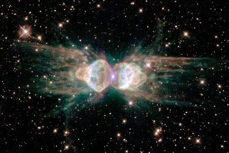 The Ant planetary nebula. Ejecting gas from the dying central star shows symmetrical patterns unlike the chaotic patterns of ordinary explosions.
