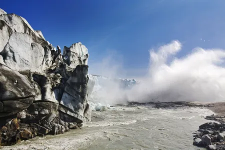 Ice collapsing off the Russell Glacier in Greenland. Researchers agree that ice-sheet melt in Greenland will lead to at least several inches of global sea-level rise by the end of the century.&nbsp;