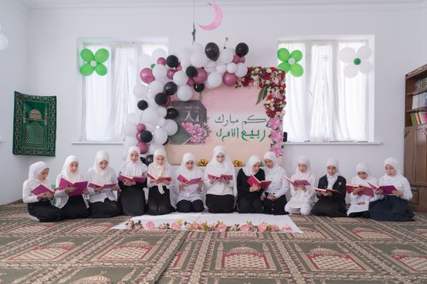 Girls from madrasahs recite suras from the Koran during a festive performance in honor of the birthday of the Prophet Muhammad thumbnail