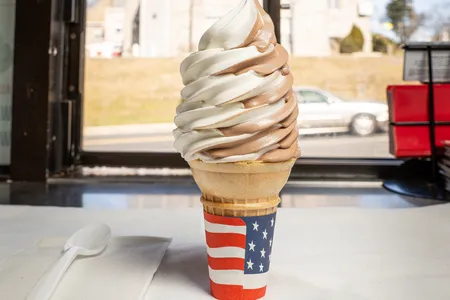 Who needs a spoon to enjoy this perfectly swirled chocolate-and-vanilla soft-serve ice cream served on a cone? Put the formalities aside.