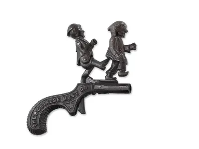 The anti-Chinese cap pistol carries the phrase “The Chinese Must Go” and shows a presumably white man kicking a Chinese man.