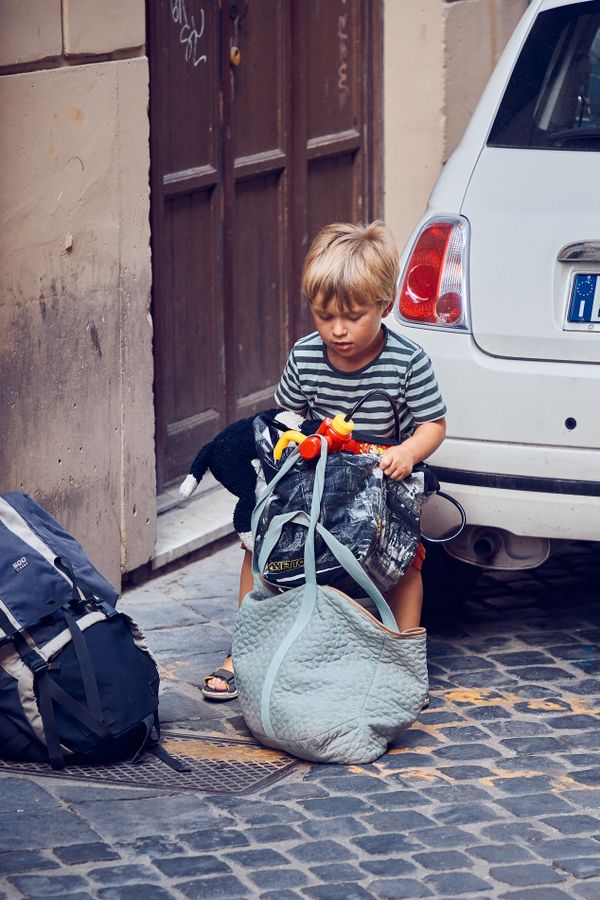 Young Roman helps his Mom to carry things home thumbnail