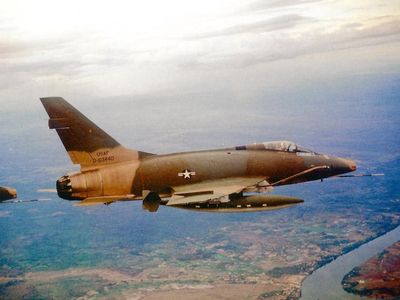 An F-100D—the same aircraft in the National Air and Space Museum collection—flies over the Mekong Delta, circa 1968.
