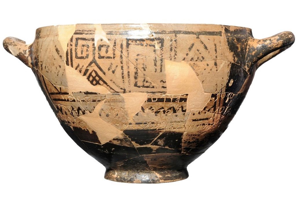 clay cup featuring black geometrical designs