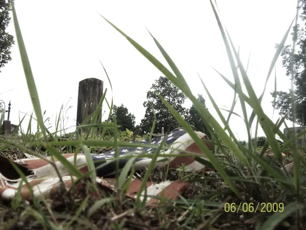 Torn American flag in cemetary thumbnail