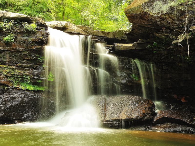 Mill Creek, West Virginia. Sliding down the very steep embankment with