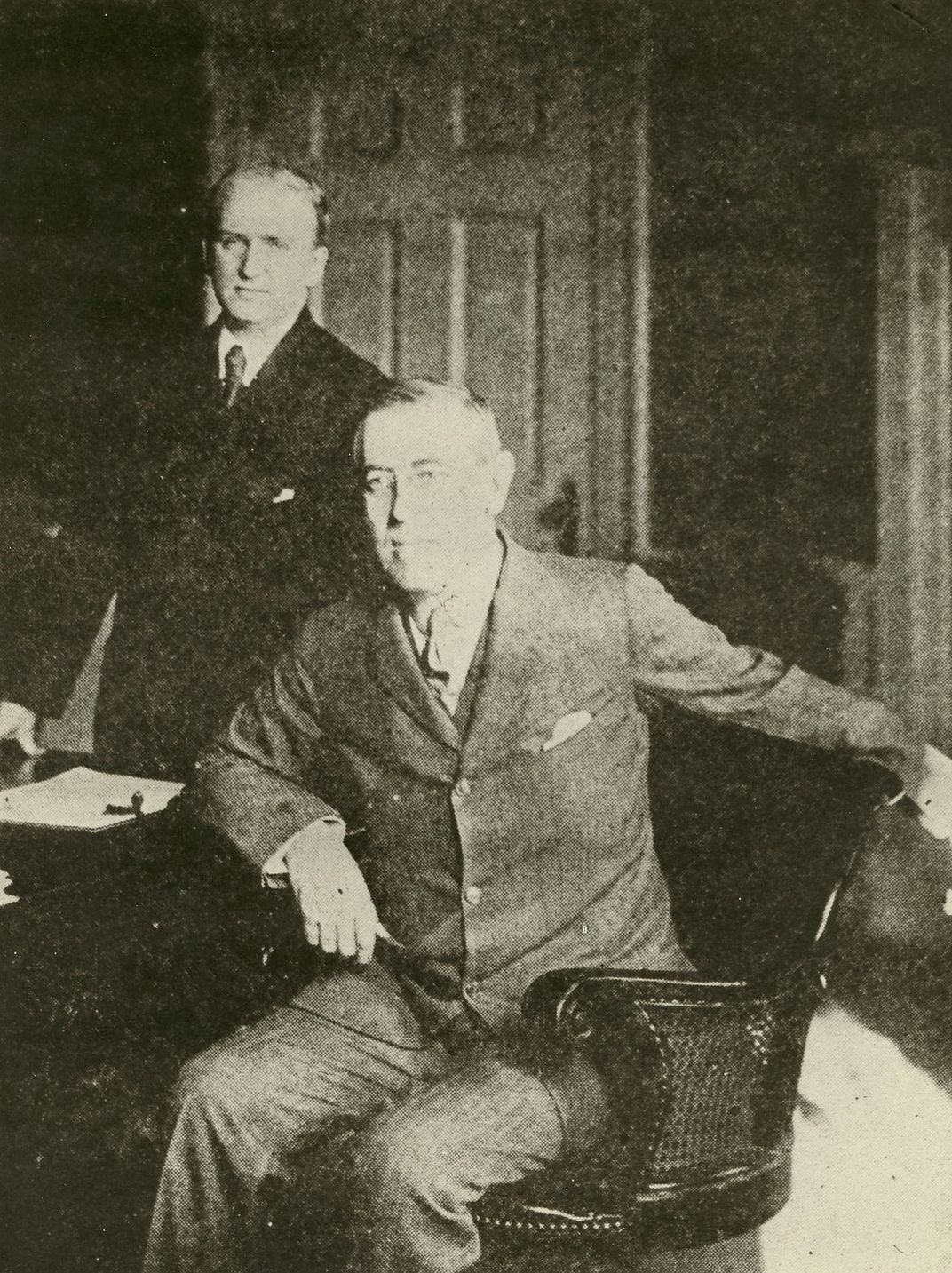 Woodrow (seated) and his secretary, Joseph Patrick Tumulty (standing)