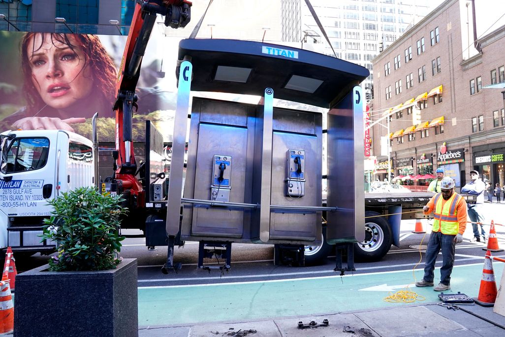 Payphone booth being removed