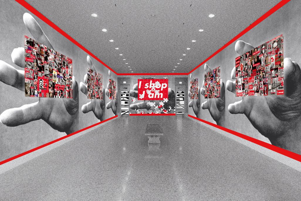 An installation view of a long hallway with gray floors, walls outlined in red
