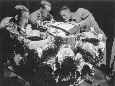 Workers assemble cylinders on a Pratt & Whitney R-2800 engine.
