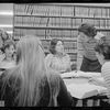 A group of women law students gathered around a table in a library.
