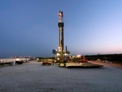 Among the many downsides of natural gas extraction are the small earthquakes caused by injecting wastewater back into the earth. Above, an oil rig drills for natural gas through shale.