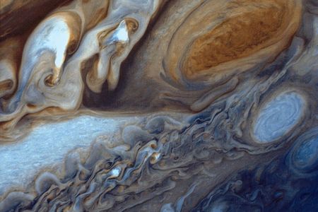 A false-color image of the Great Red Spot of Jupiter from Voyager 1. The white oval storm directly below the Great Red Spot has approximately the same diameter as the Earth.
