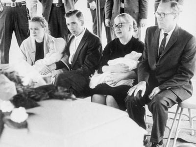 The Oswald family—with Marguerite Oswald second from right—sit next to Lee Harvey Oswald's casket.