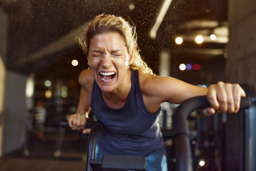 woman yelling while working out on an elliptical