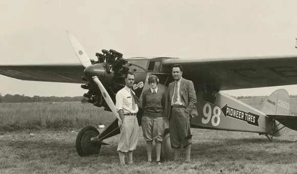 Three-quarter left front view of Cessna BW-5 (r/n C6623, National Air Races race no. 98) on the ground, possibly at Roosevelt Field, Long Island, New York, circa September 1928. Posed standing beside nose of aircraft are pilot Francis D. 