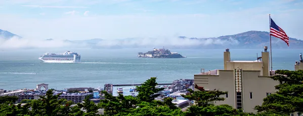 View on a cruise ship, Alcatraz and American flag thumbnail