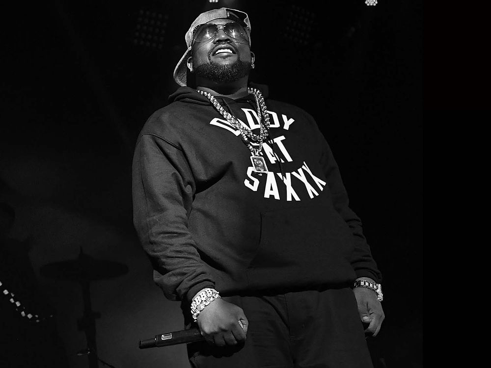 a black and white photograph of a hip-hop artist on stage