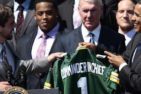 President Barack Obama is presented with a team jersey by the Green Bay Packers' quarterback Aaron Rodgers during a ceremony at the White House after Super Bowl XLV.