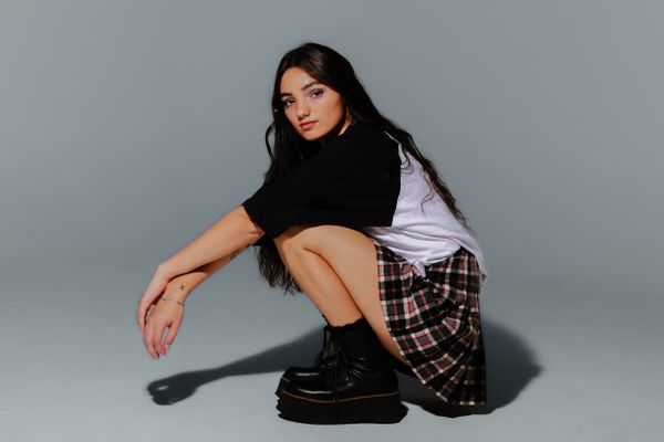 A young woman in her father's vintage band tee thumbnail