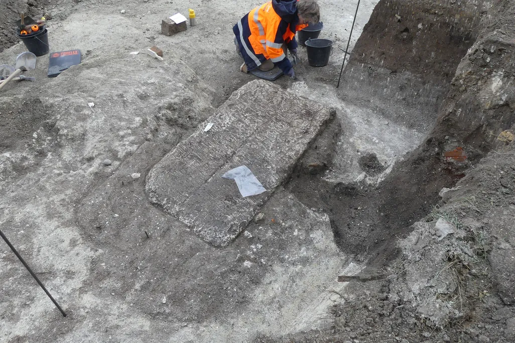 Limestone sarcophagus being excavated