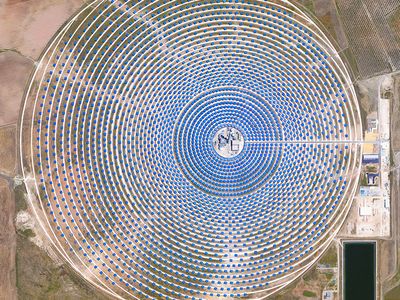 Gemasolar Thermasolar Plant, 37.560755°, –5.331908° This image captures the Gemasolar Thermosolar Plant in Seville, Spain. The solar concentrator contains 2,650 heliostat mirrors that focus the sun’s thermal energy to heat molten salt flowing through a 140-metre-tall (460-foot) central tower. The molten salt then circulates from the tower to a storage tank, where it is used to produce steam and generate electricity. In total, the facility displaces approximately 30,000 tonnes of carbon dioxide emissions every year.