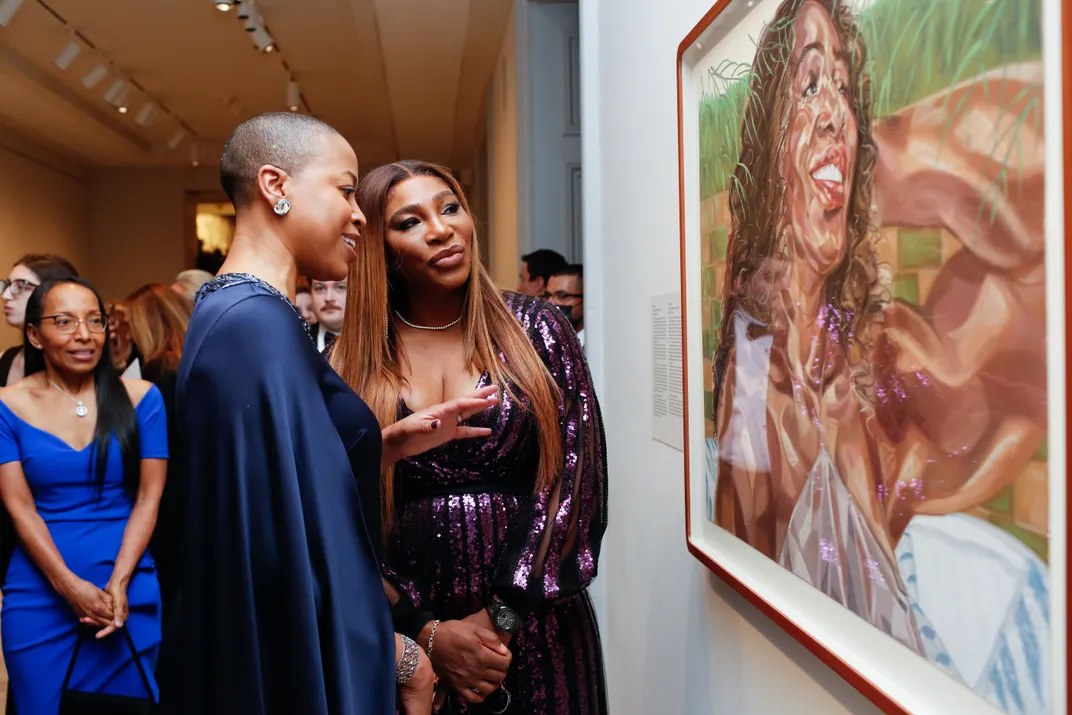 Rhea L. Combs (left) and Serena Williams (right) admire Williams' portrait at the Portrait of a Nation Gala.
