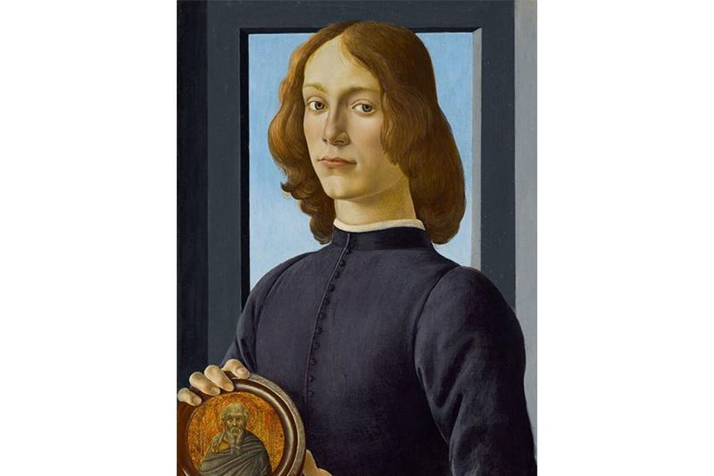 A young man faces the viewer, with gray-green eyes, pale skin and gold-brown hair, wearing a dark purple tunic, in front of a simple gray window with a plain blue sky; holds a circular medallion with his two hands depicting an elderly saint