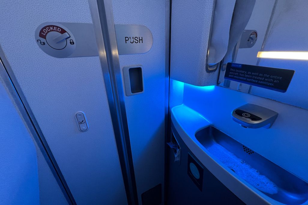 Blue light glowing inside airplane lavatories