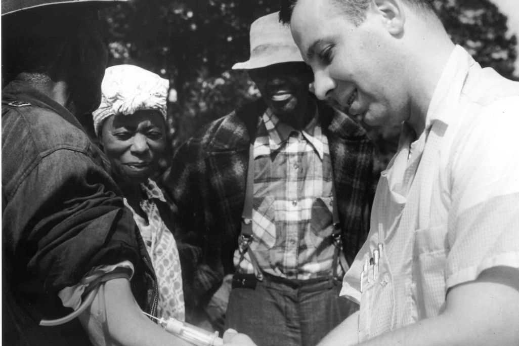 A Tuskegee study subject gets his blood drawn in the mid-20th century.