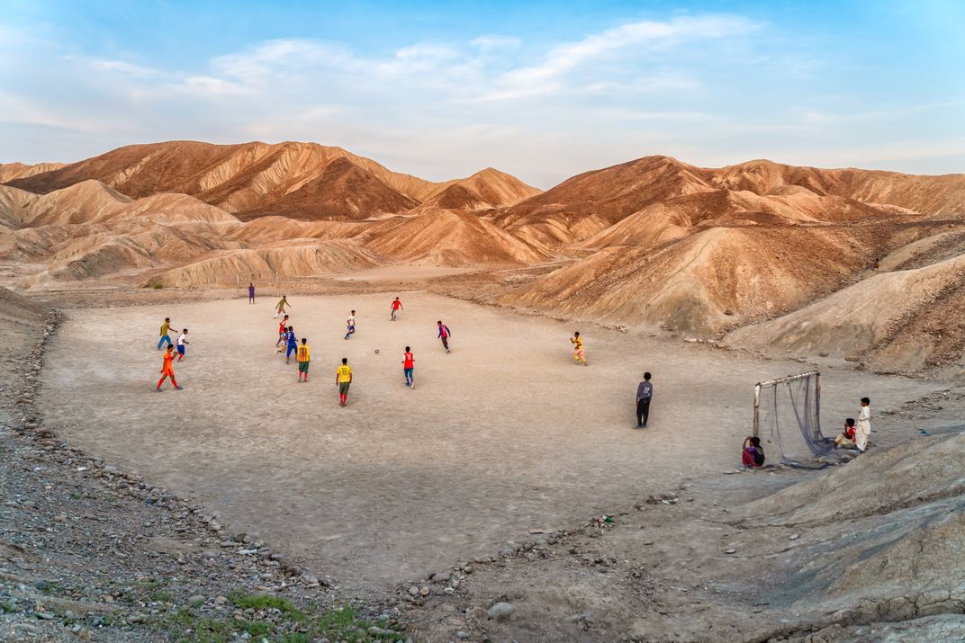 a soccer match is played in a hilly desert setting