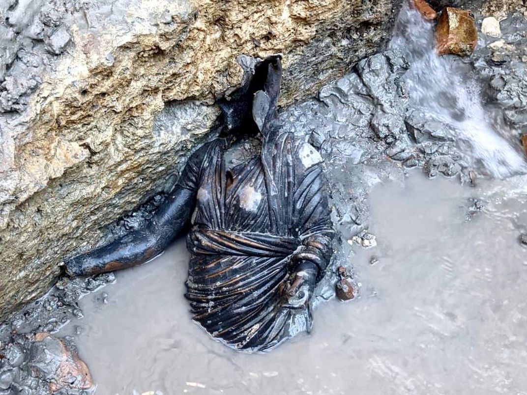 An ancient statue preserved in a thermal bath outside of Siena, Italy