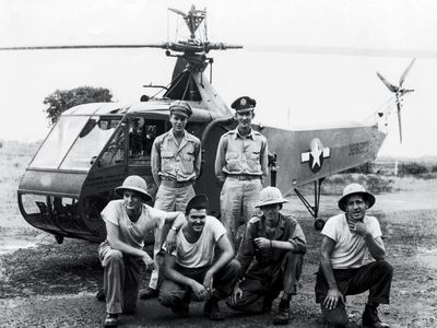 In eastern India in 1944, Carter Harman (standing, left, next to his co-pilot) had the extremely rare job of helicopter pilot.The maintainers with him, members of the 1st Air Commando group, were among the first to service helicopters in the field.
