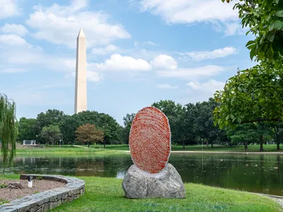 Wendy Red Star&rsquo;s The Soil You See&hellip; is a seven-foot-tall glass red thumbprint featuring the names of chiefs who signed treaties with the American government, usually with a fingerprint.