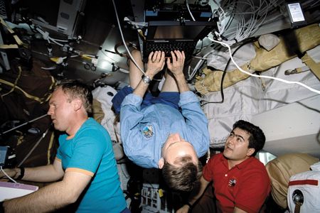 Joe Edwards (center) learned that in space, there is no up or down.