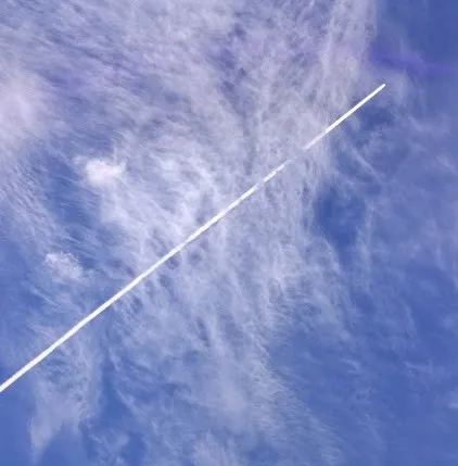 A commercial jet leaves a condensation trail behind it thumbnail
