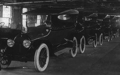 A row of brand new Cadillacs awaits drivers. 1917
