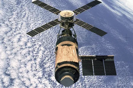 An image of Skylab captured by its final crew as they departed. During launch, one of the solar array wings broke off, and the gold sheet at the center was quickly manufactured afterward to serve as a makeshift sunshield and control the internal temperature.