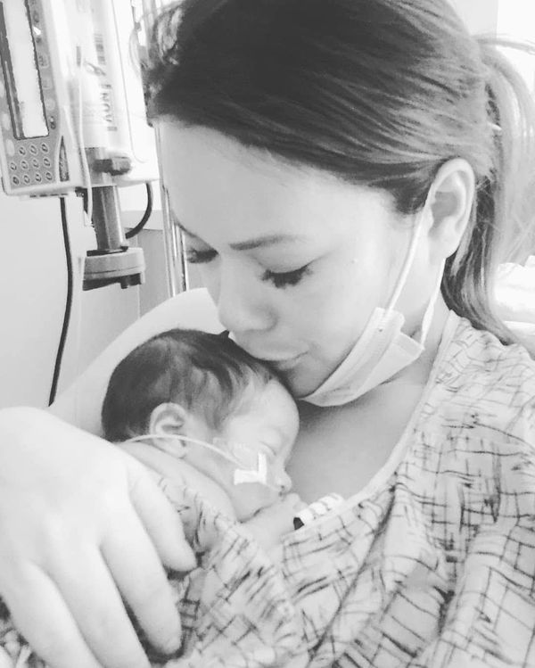 A mother holding her daughter for the first time in the NICU thumbnail