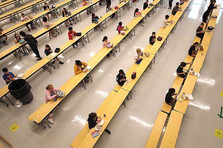 School children are spaced apart in one of the rooms used for lunch at Woodland Elementary School in Milford, Massachusetts on Sept. 11, 2020.