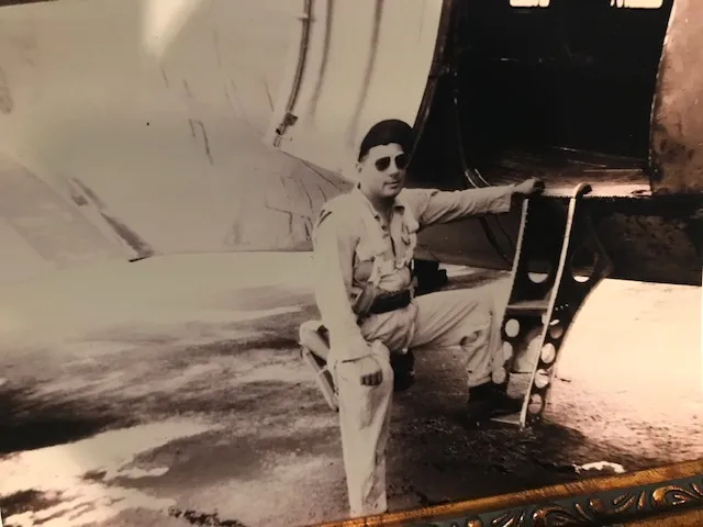 Philip Kahn stands next to WWII B-29 bomber plane.