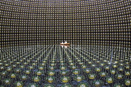 The cavernous Super-Kamiokande detector in Japan is lined with 13,000 sensors to pinpoint signs of neutrinos.