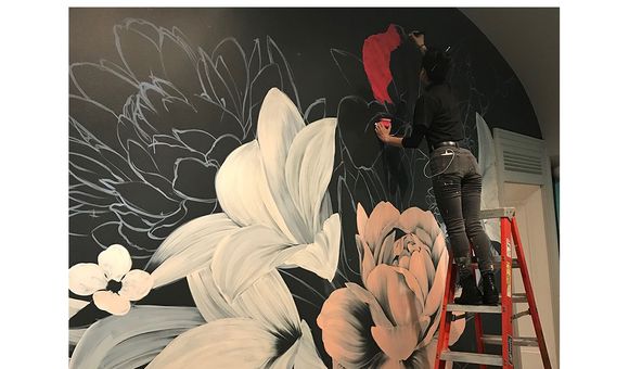 The artist Louise Jones, known as Ouizi, working on Adaptation Nocturne.