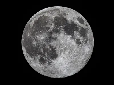 The full moon, as seen from Granada, Spain. A new study suggests the moon is shrinking, causing moonquakes that could interfere with planned lunar missions.