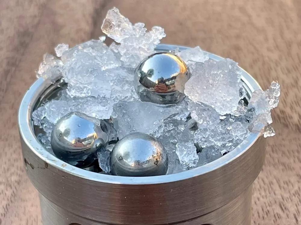 ice and balls in jar on wood table