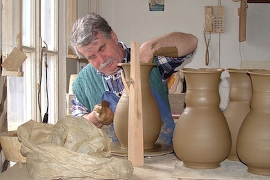 A professional potter works on his craft in Mezőtúr, Hungary, a town known for its traditional pottery-making.