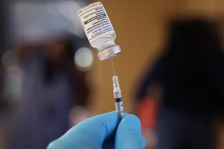 A pharmacist prepares to administer a Covid-19 booster shot to help protect a patient against the Omicron subvariants BA.4 and BA.5.