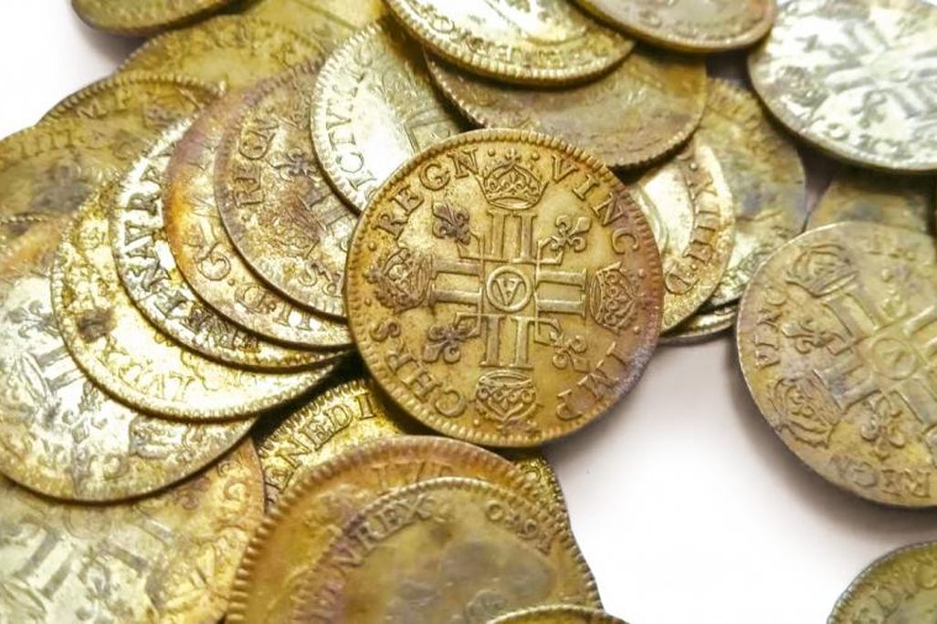 A close up shot of a pile of gold coins