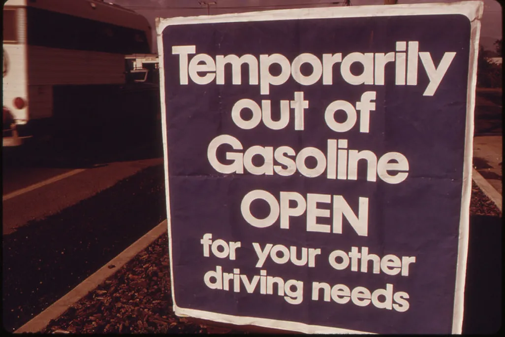 Sign reading "Temporarily out of gasoline. Open for your other driving needs"