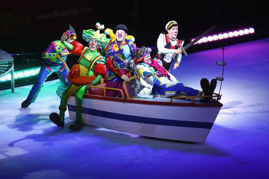 A group of clowns in a boat onstage